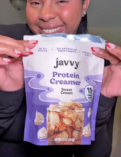 Customer holding up a bag of Sweet Cream Protein Creamer