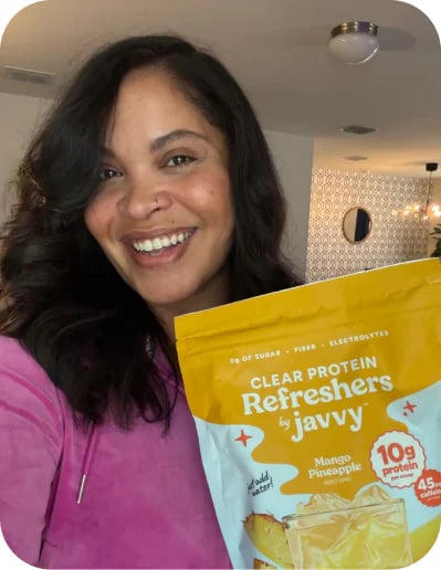 Customer smiling with a bag of Javvy Protein Refreshers