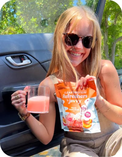 Customer in her car holding a Protein Refresher