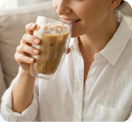 Woman sipping an iced protein coffee