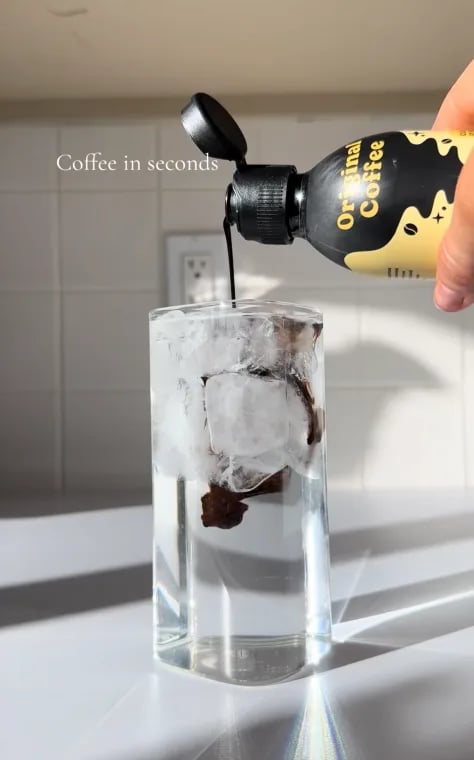 Original Coffee Concentrate poured into a glass of ice water