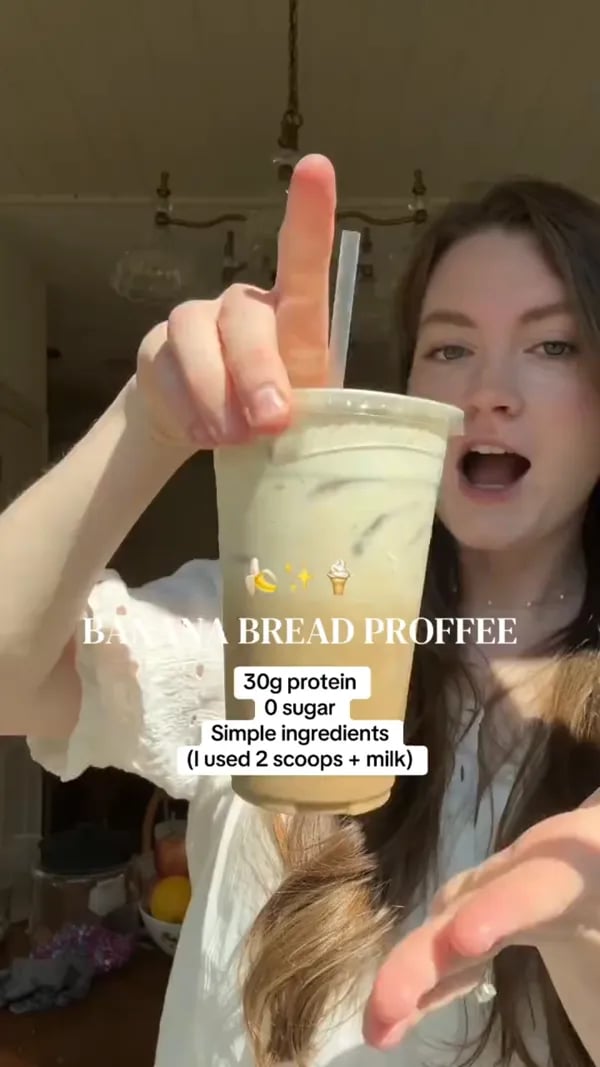 Customer showing an iced Banana Bread protein coffee