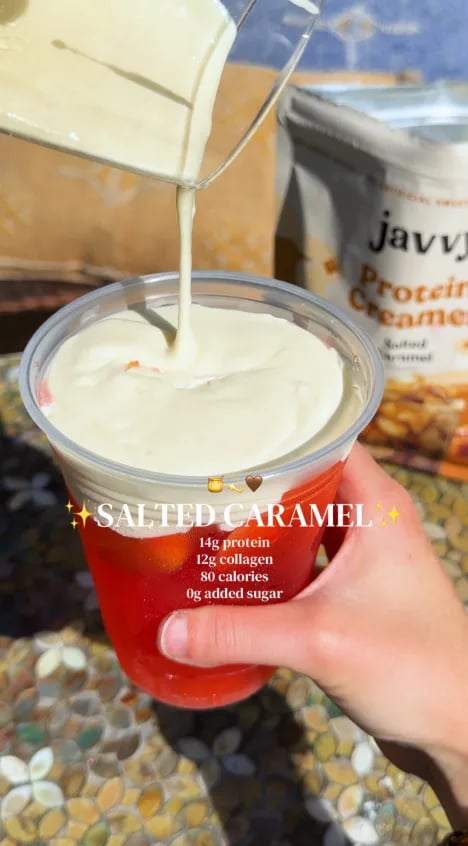 Customer pouring Salted Caramel Protein Creamer over an iced drink