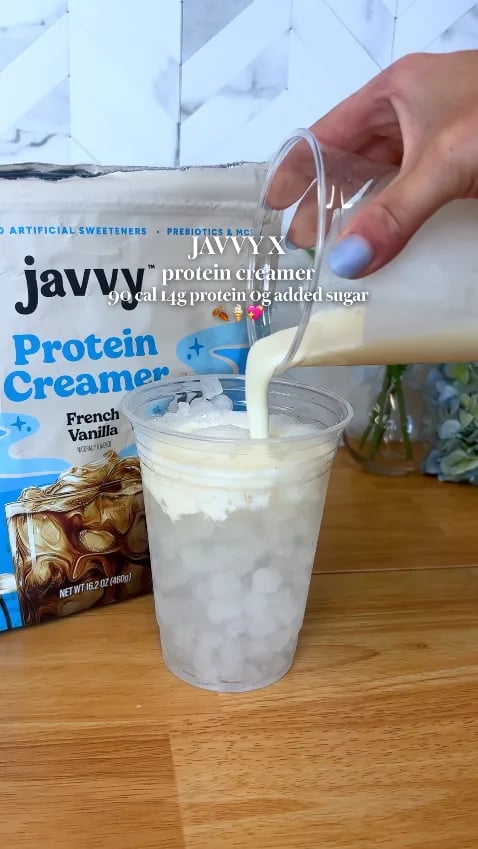 Customer pouring French Vanilla Protein Creamer over iced coffee