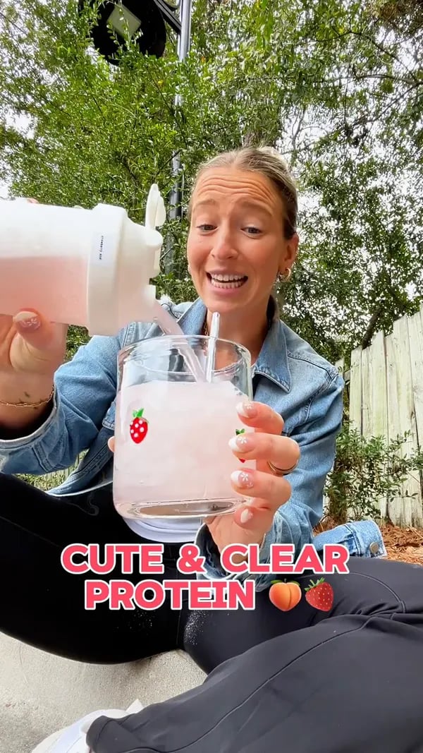Customer mixing a Peach Passionfruit Protein Refresher outdoors