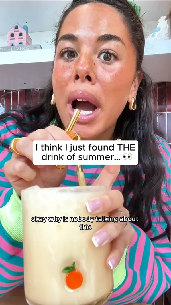 Customer sipping a Mango Pineapple Protein Refresher