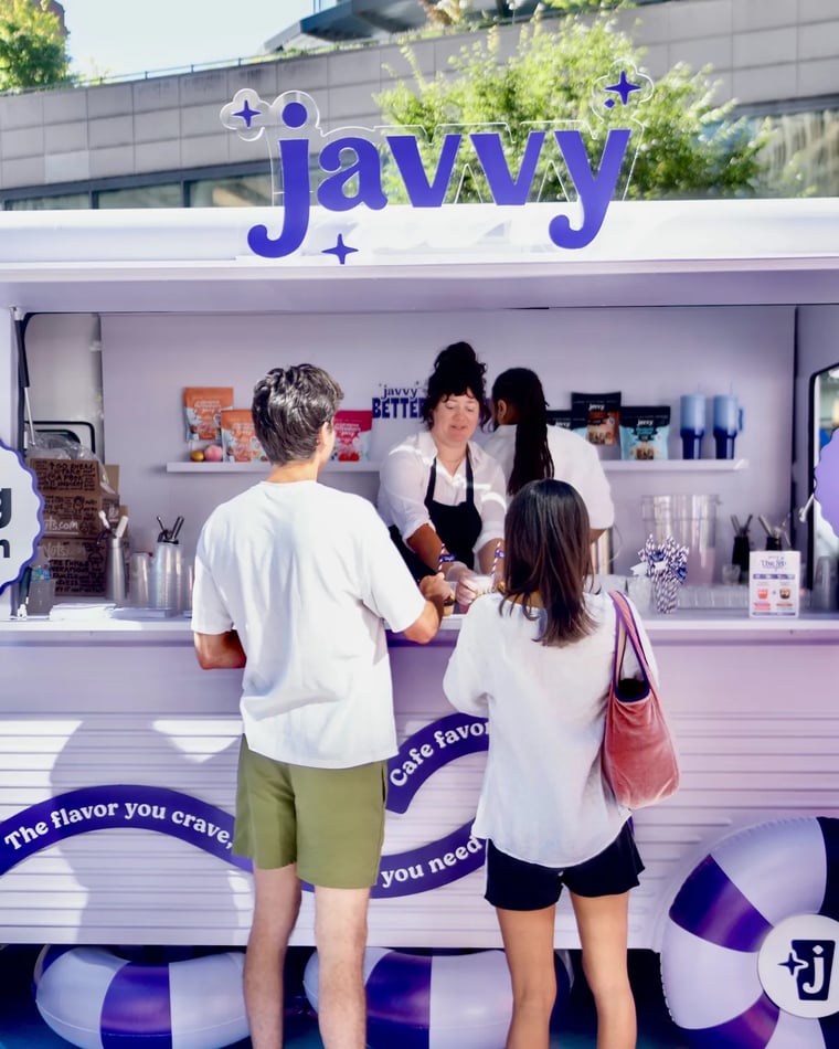Customers ordering at a Javvy coffee cart