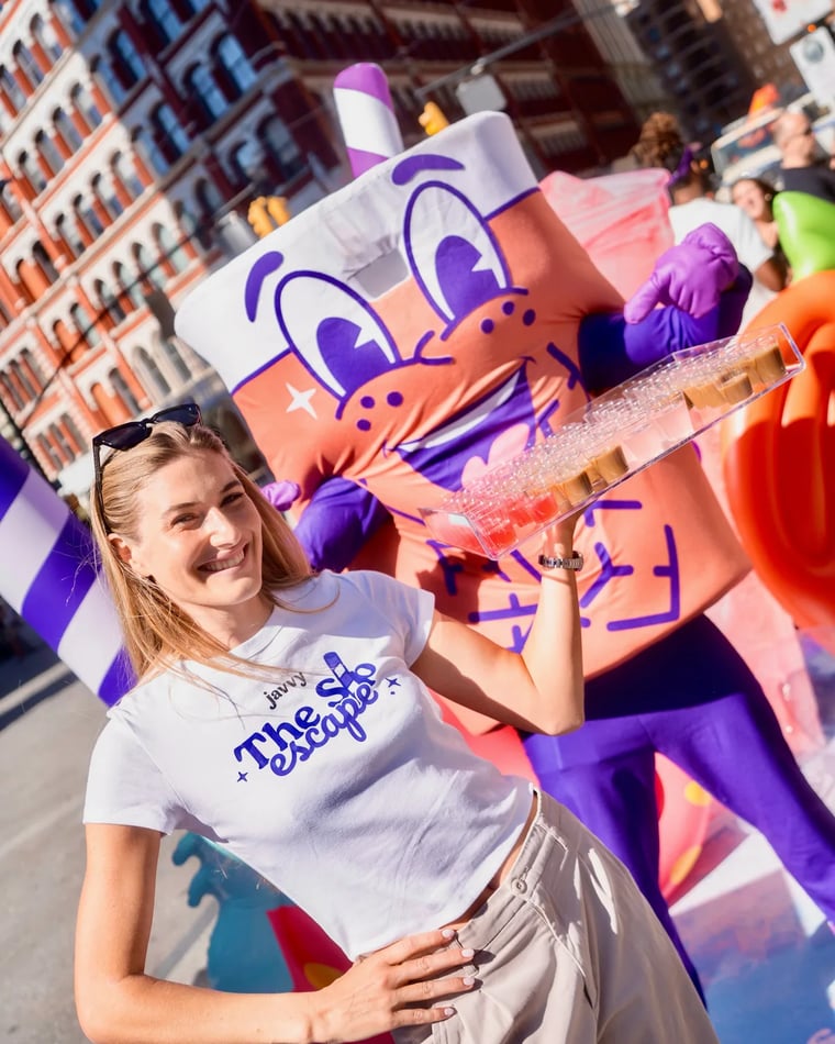 Customer with a Javvy drink next to the Javvy mascot