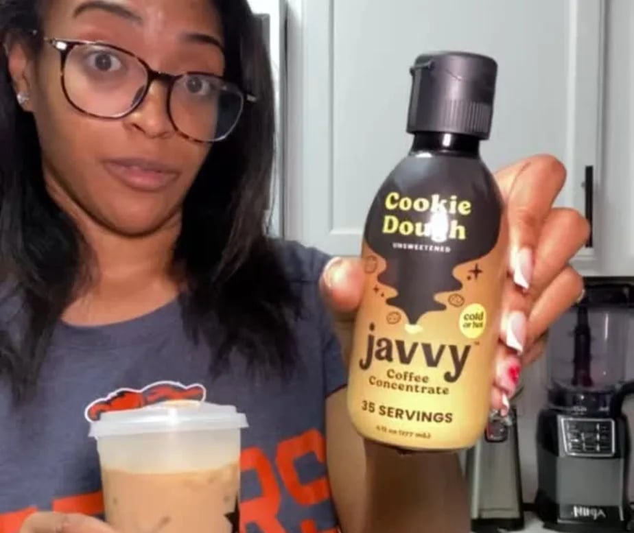 Customer showing a bottle of Cookie Dough Coffee Concentrate and an iced coffee